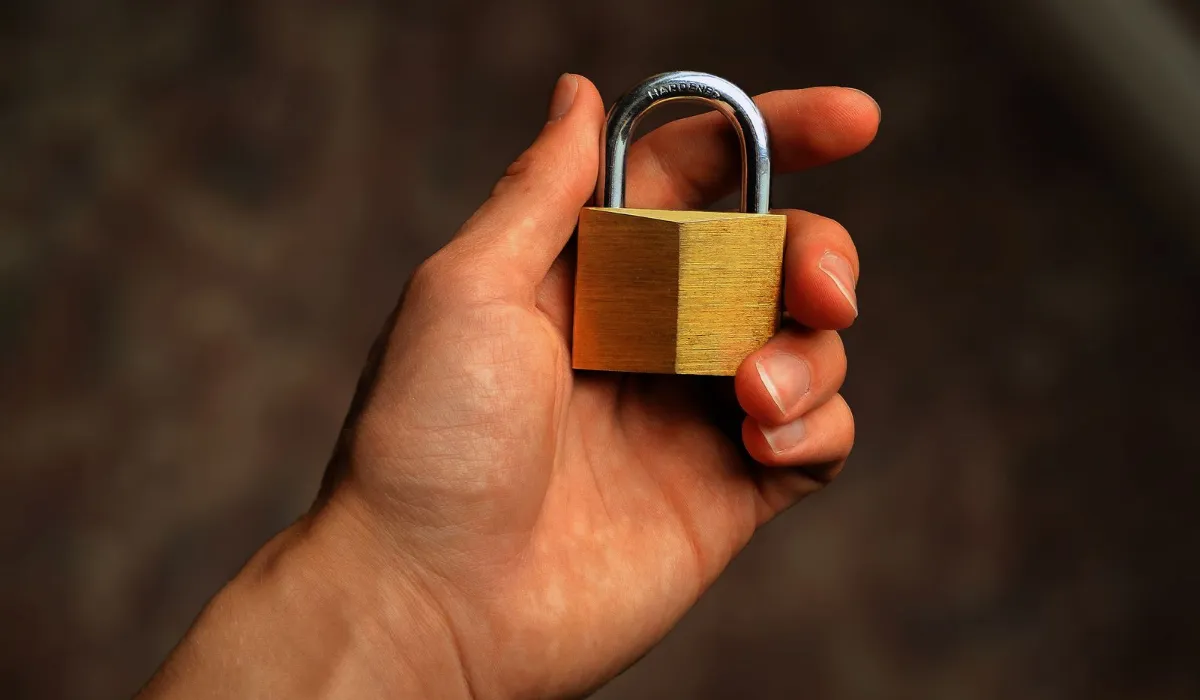 A small brass padlock on a phone