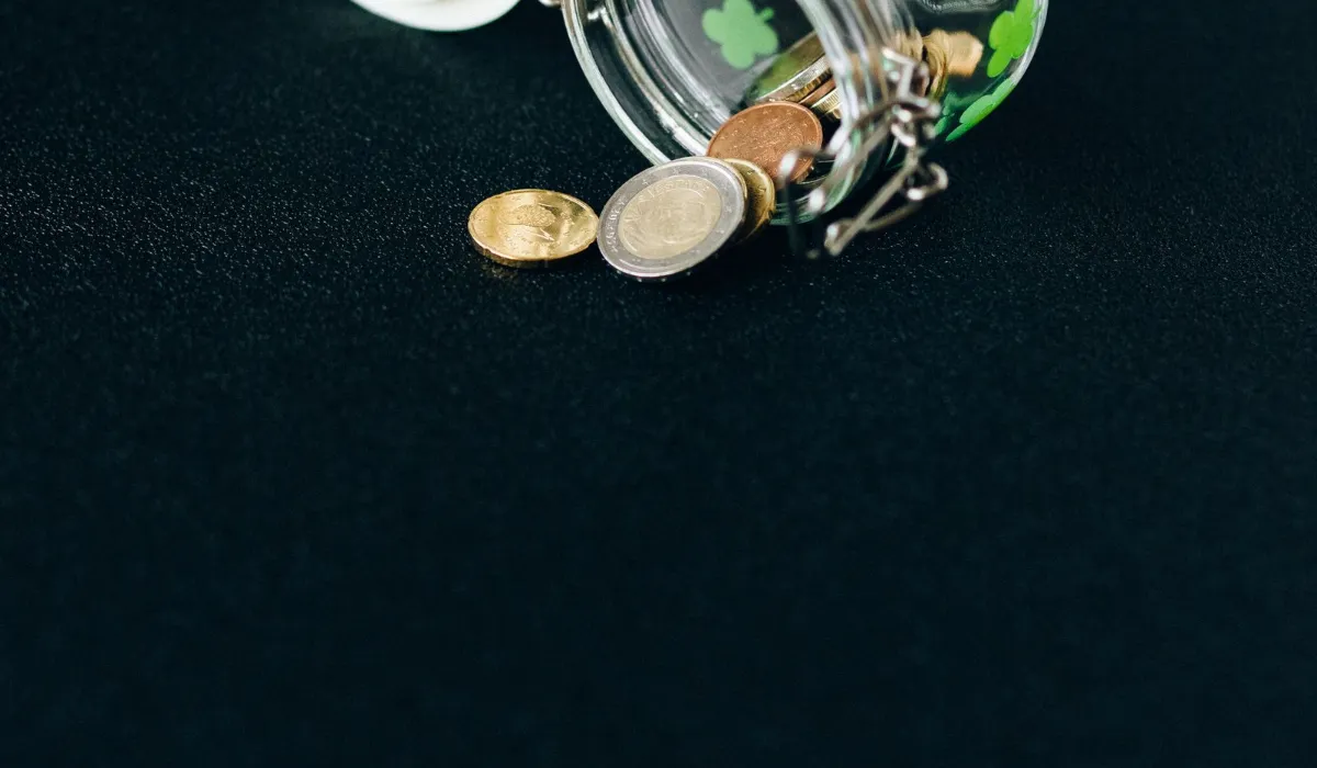 A glass jar of coins beside a subscription card, illustrating tokens on top of a subscription
